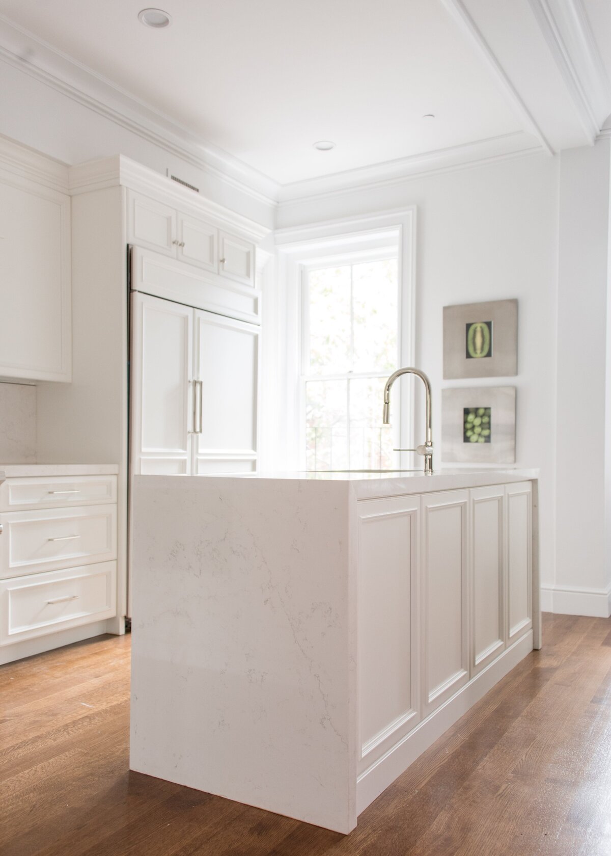 bright-white-kitchen-waterfall-island-paneled-cabinets-comm-ave-min