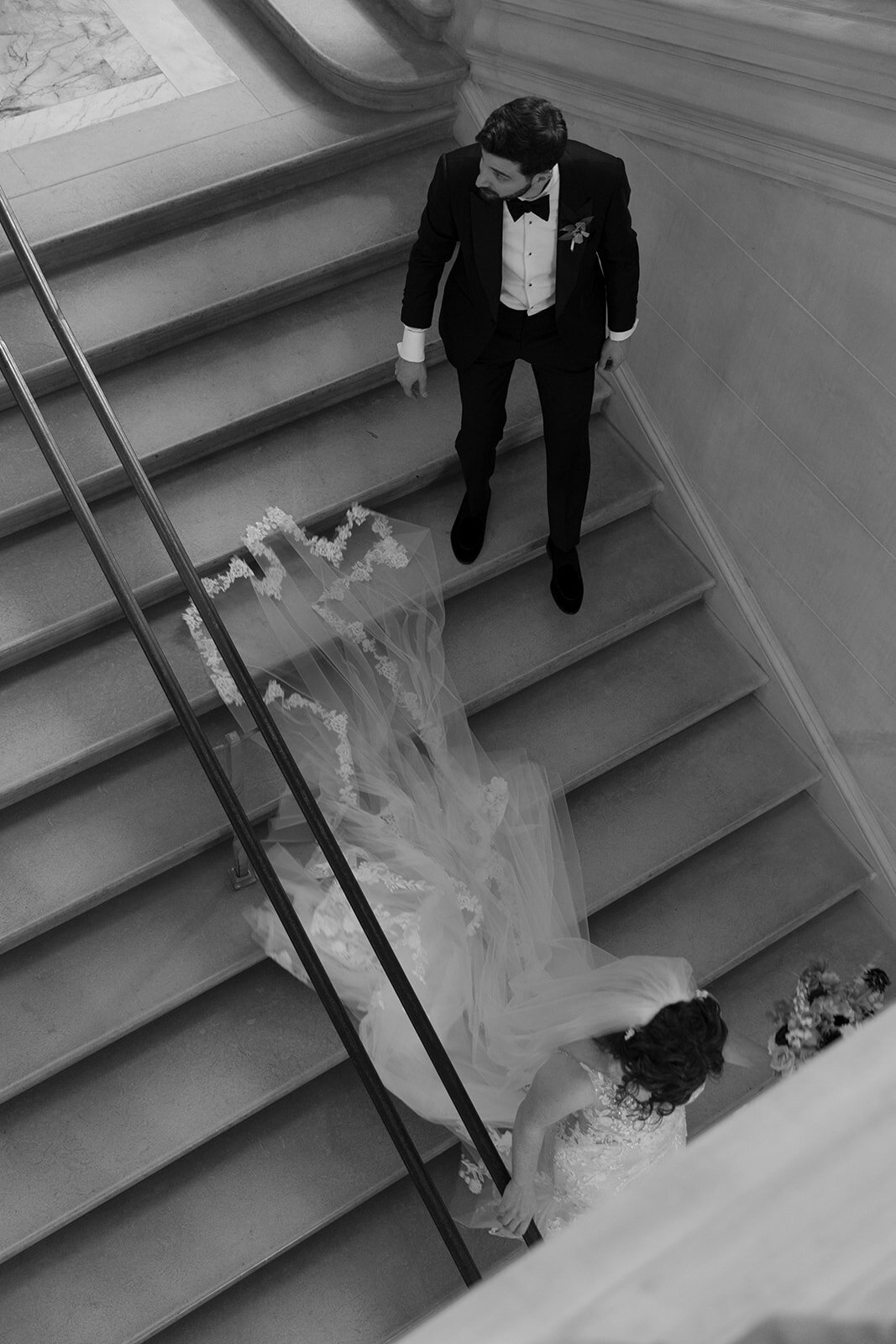 Couple posing walking down stairs