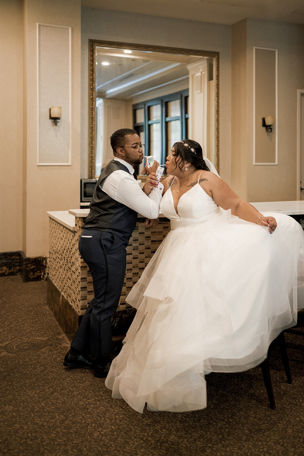 couple drinks juice boxes after wedding ceremony