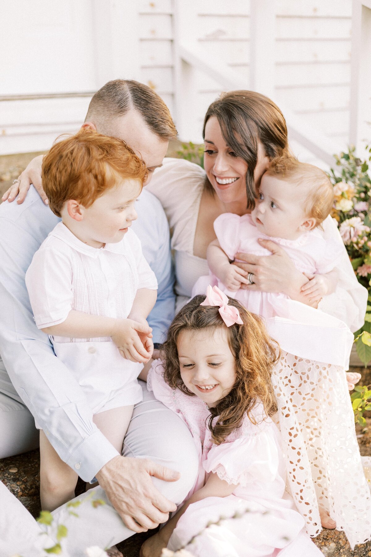 family sitting on steps outside and laughing during peoria, illinois photos 