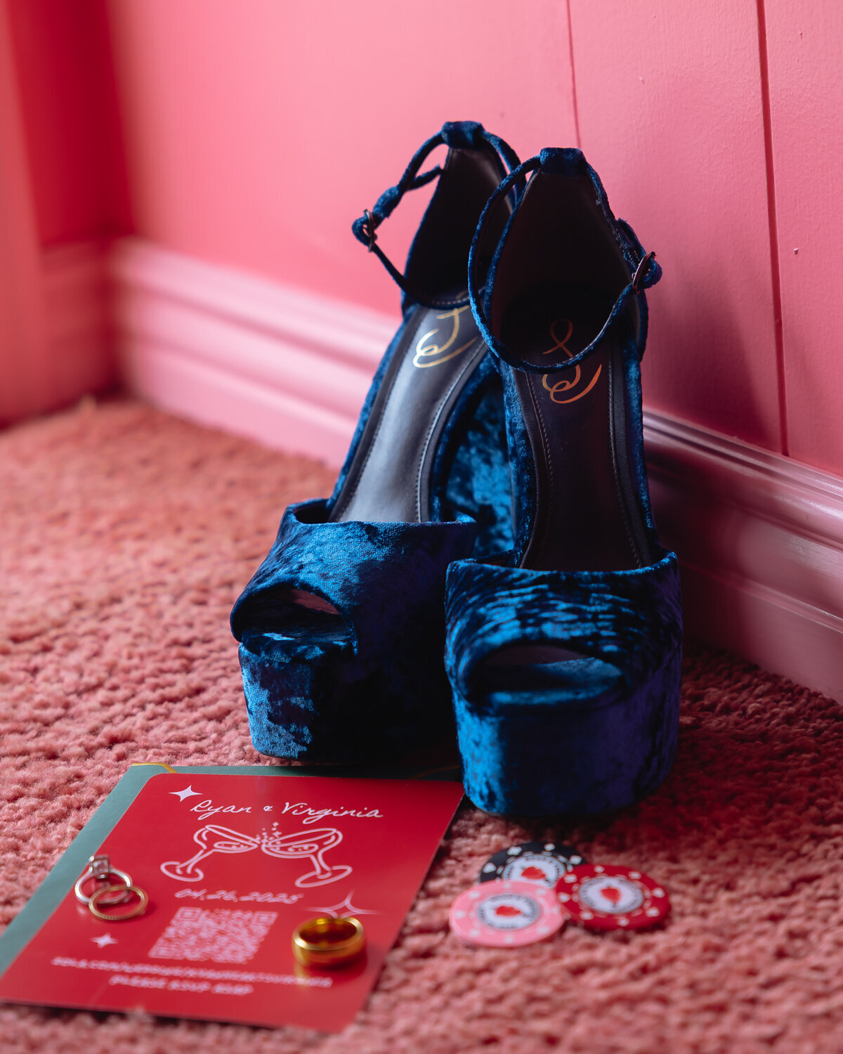 Madonna Inn wedding photos of details brides blue shoes with wedding invitations and wedding rings in San Luis Obispo