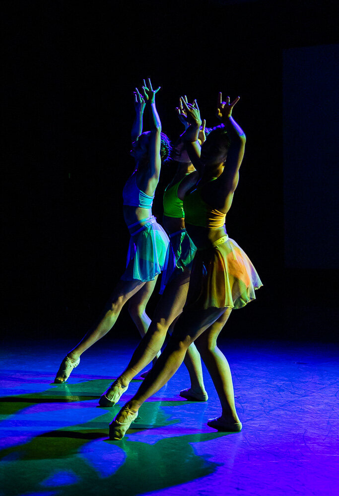 Girls in vibrant dance attire on stage