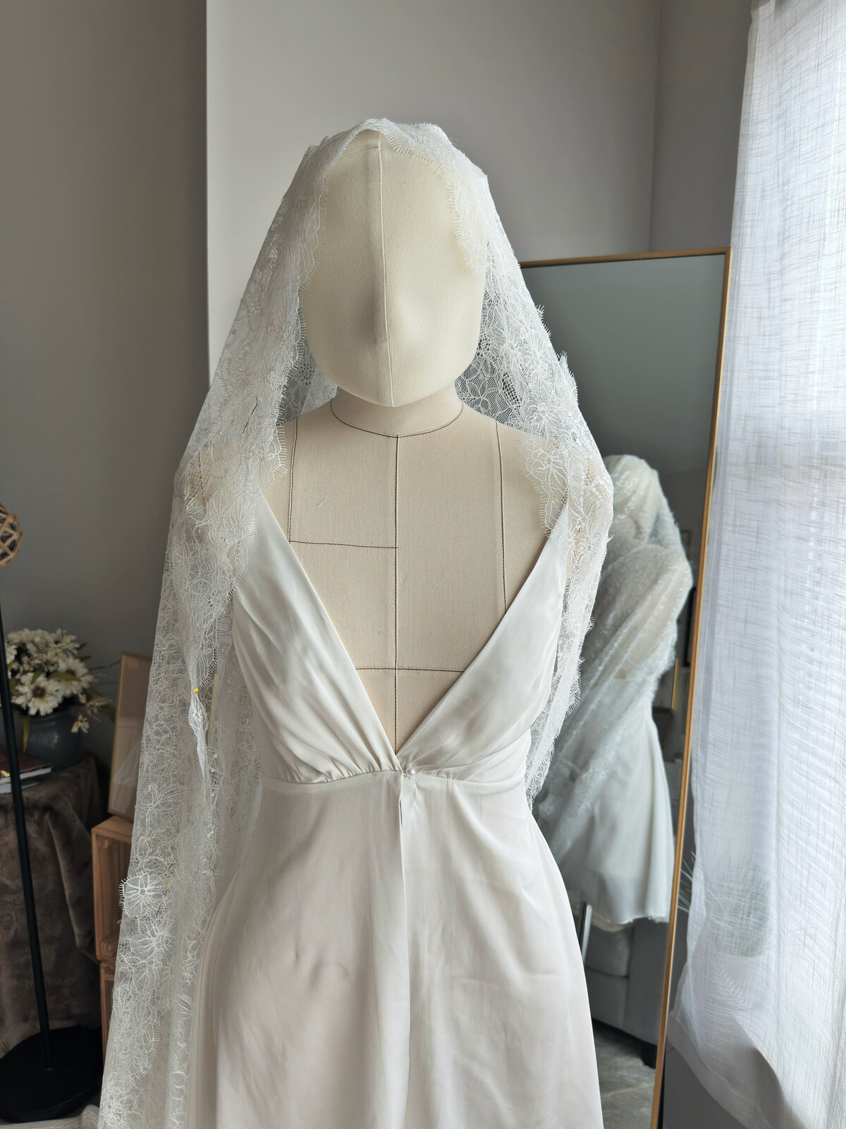 Romantic cathedral-length mantilla veil draped over soft curls
