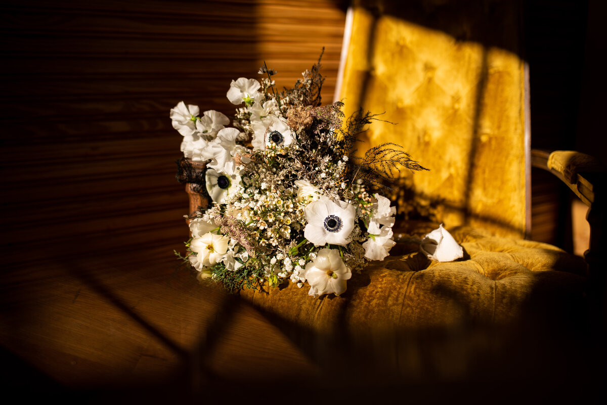 bridal bouquet laying on yellow chair