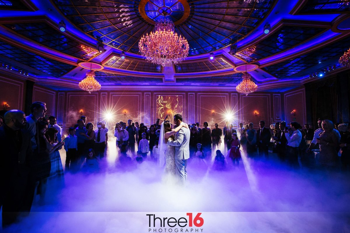 Bride and Groom's first dance as a newly married wife with a purplish hue to the fog on the ground