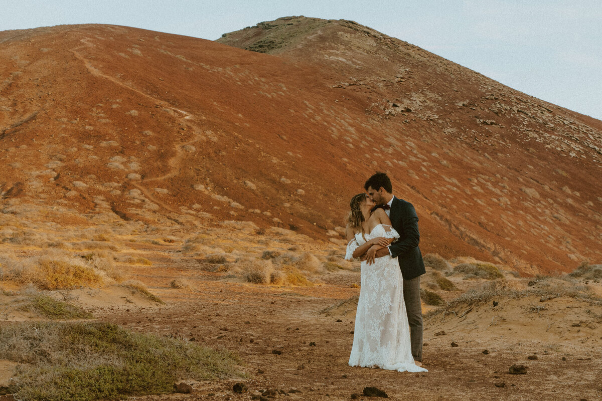 Groom holding bride from behind