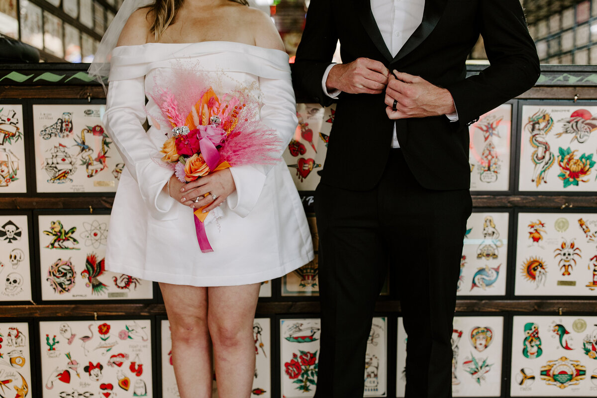 Close up of a white dress and tuxedo during an elopement.