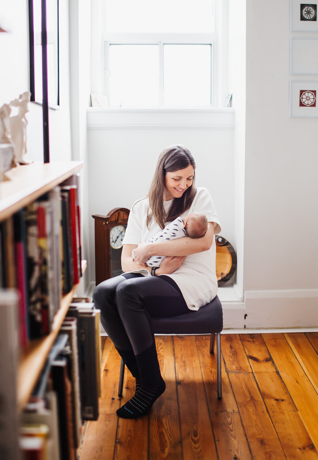giving new sister a kiss while kitty looks on at Toronto Newborn Lifestyle photo session