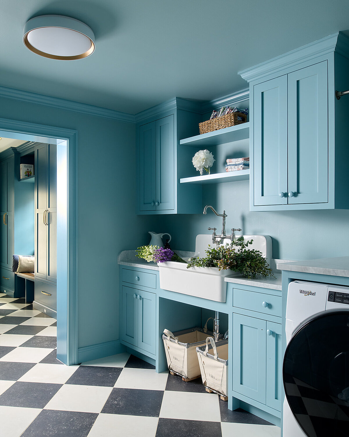 sky blue laundry room with built-in cabinets and open shelves