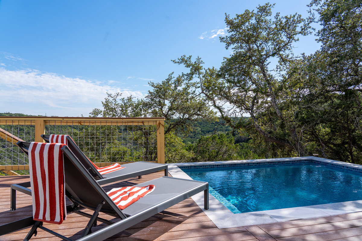 railing outside pool with wood deck and seating