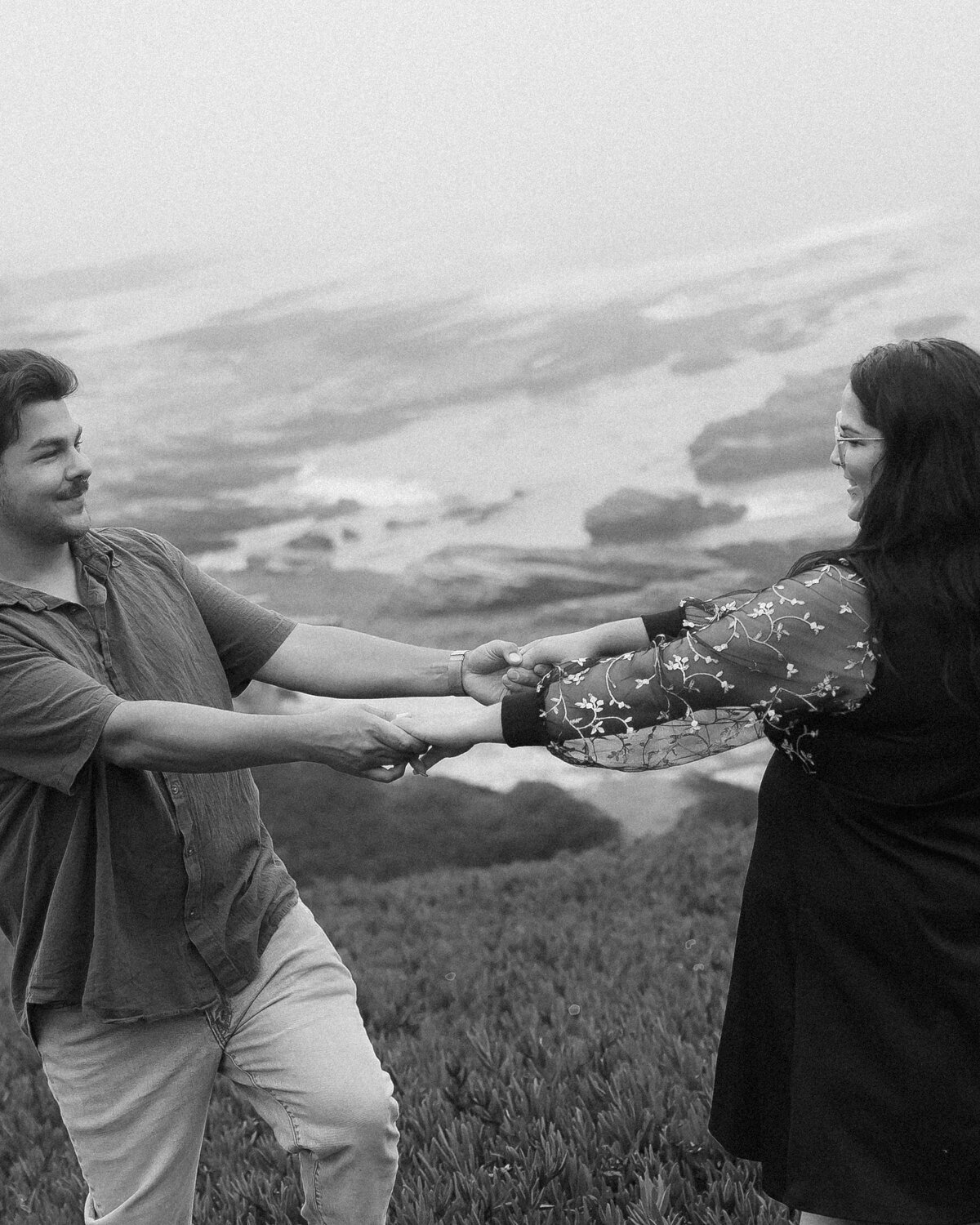 Candid Couples engagement photos at Montana De Oro on the Central Coast, black and white with couple dancing