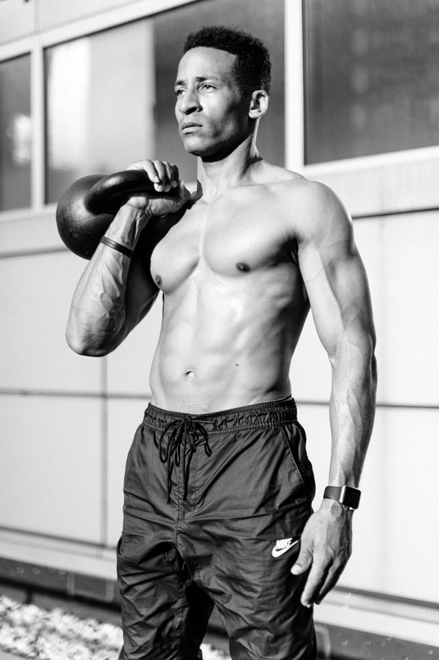 man holding a kettlebell for nyc photoshoot
