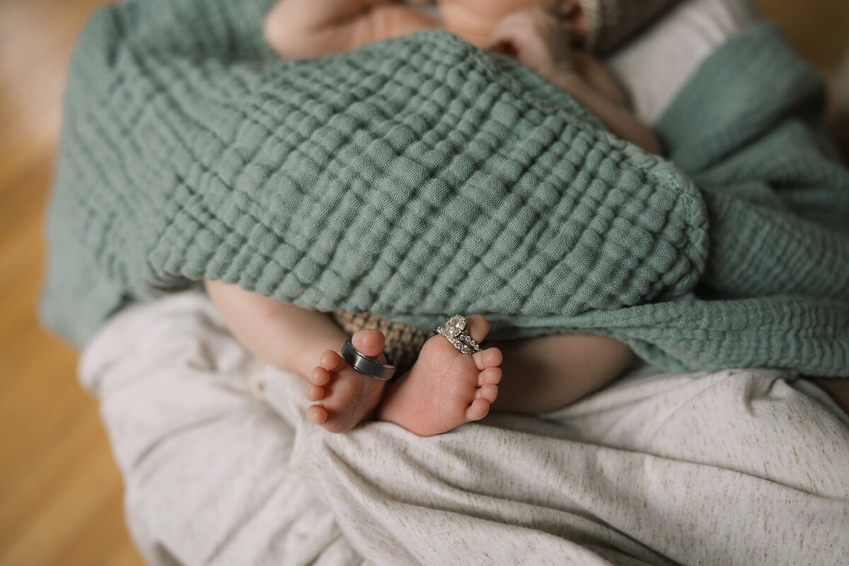 At home newborn session cuddled on the couch - Finger Lakes newborn session
