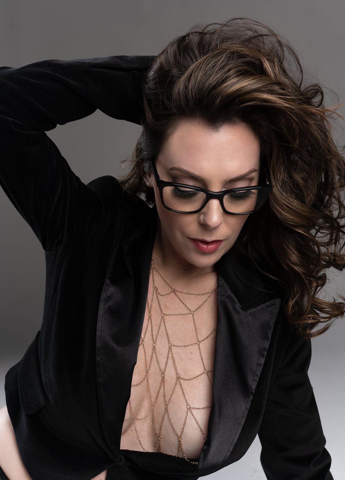 woman in glasses and blazer fashion inspired portrait