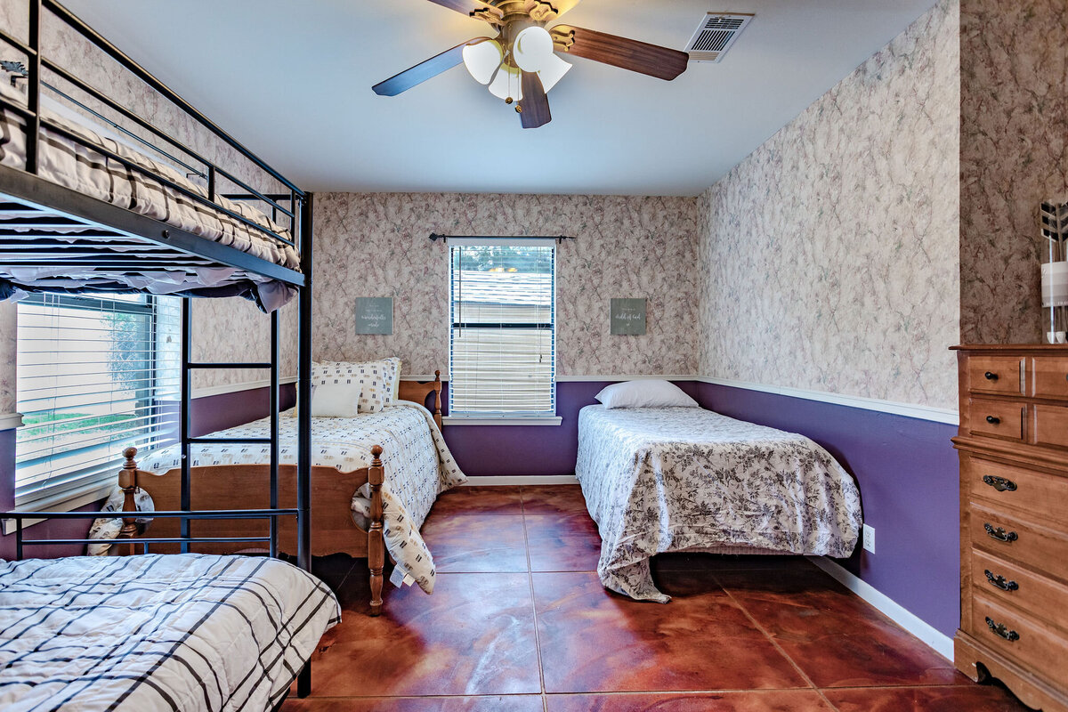 Bedroom with two beds and a set of bunk beds in this three-bedroom, two-bathroom ranch house for 7 with incredible hiking, wildlife and views.
