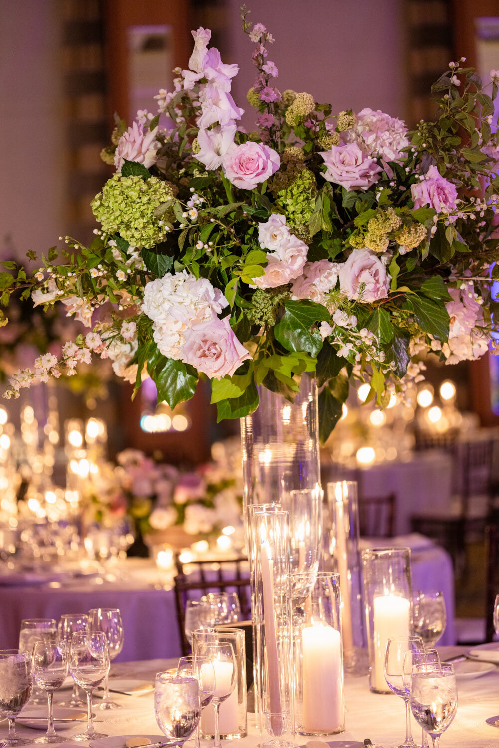 A vase filled with pink and white flowers sits on a table