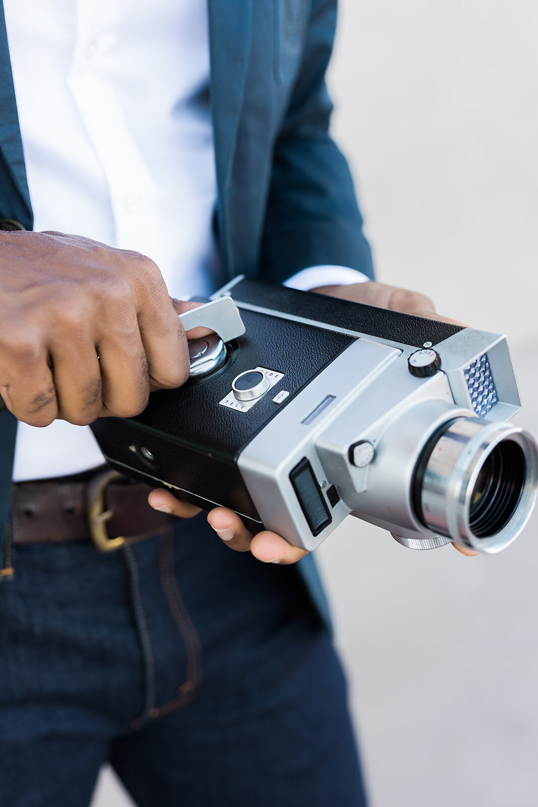 Close up of camera with a hand adjusting its dials