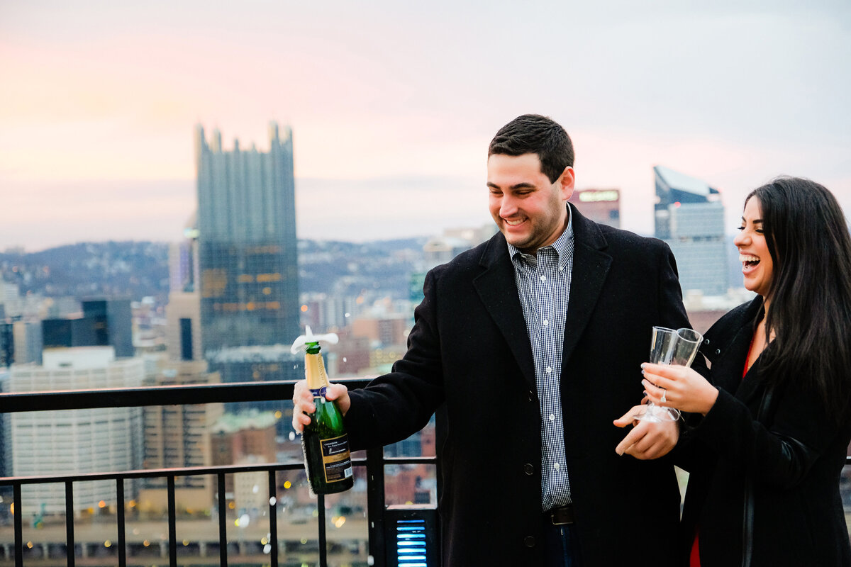 celebrating recent engagement with champagne at mt washington overlook pittsburgh