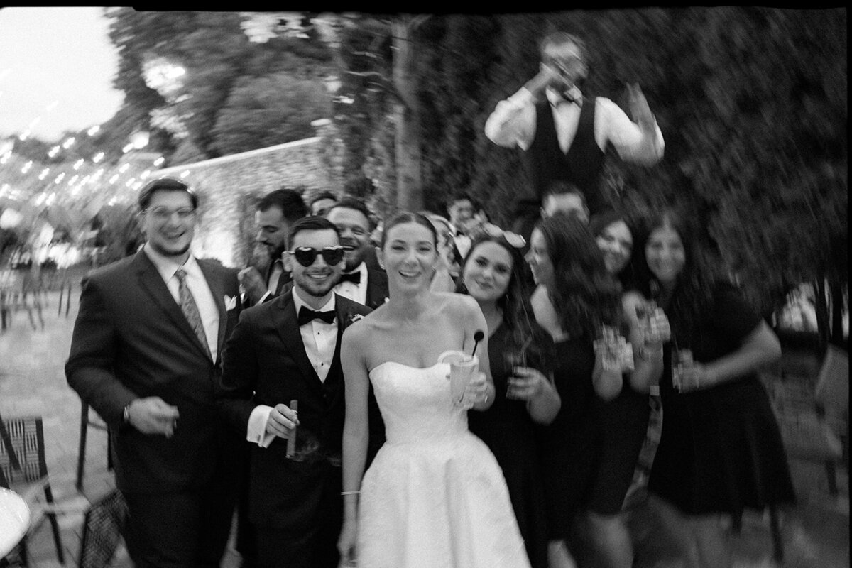 Bride and groom celebrate with bridal party in candid photo shot at Fox Hollow the Somerly on Long Island in New York. 