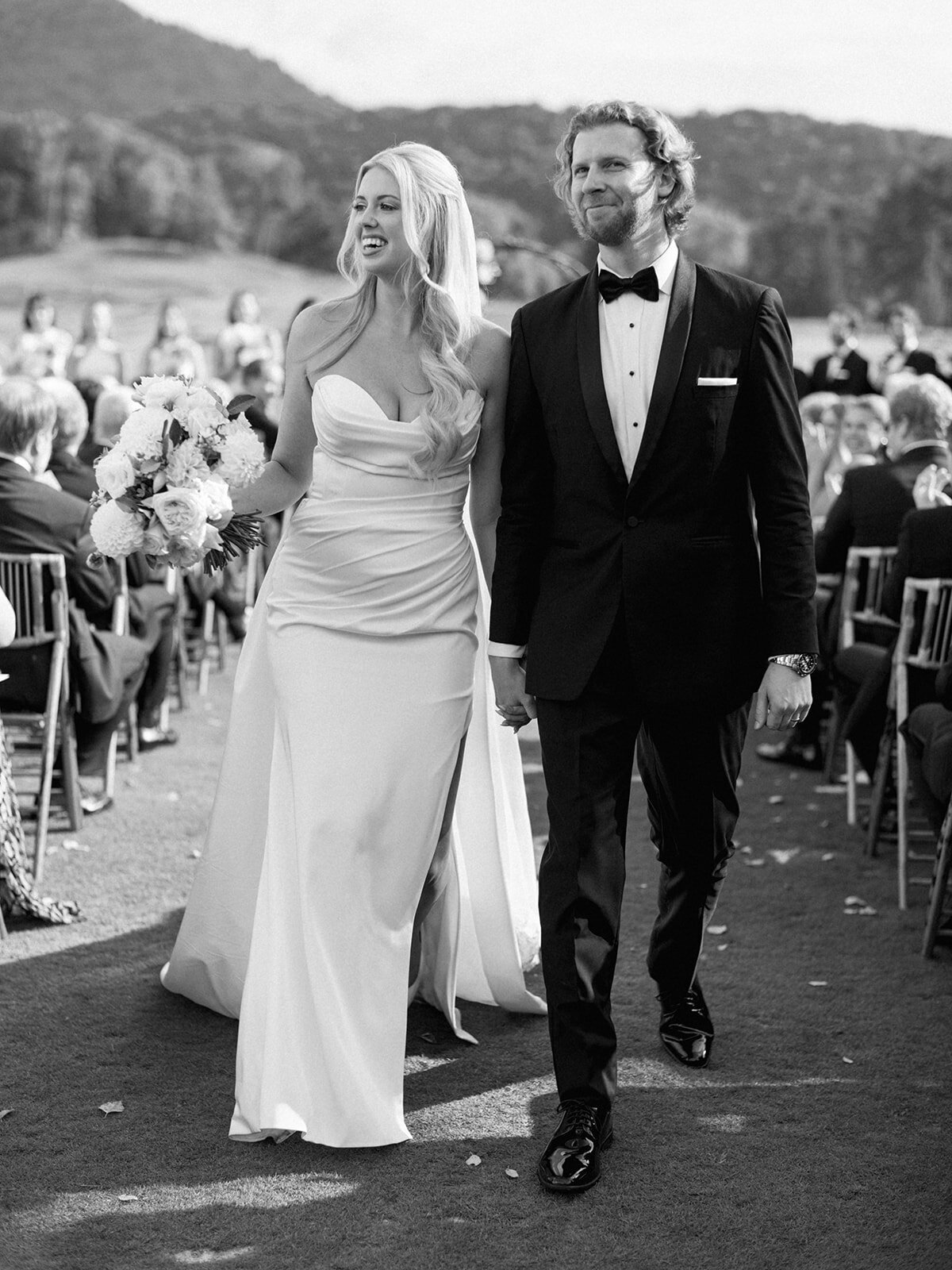 Bride and groom smiling and walking up the aisle after saying “I do” at Waynesville Inn wedding ceremony.
