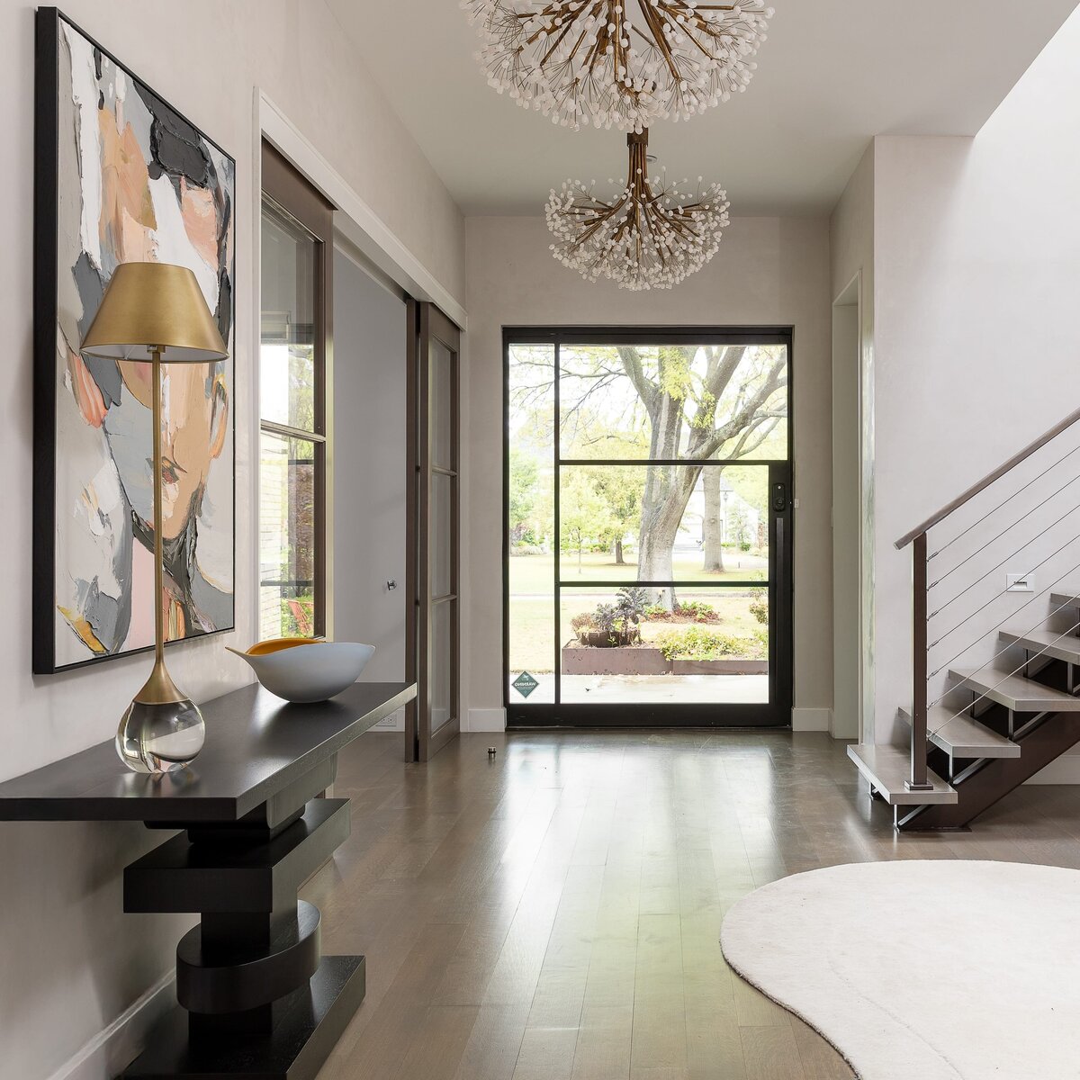 rebekah nicole interiors arbor entry way of glass front door and wood flooring