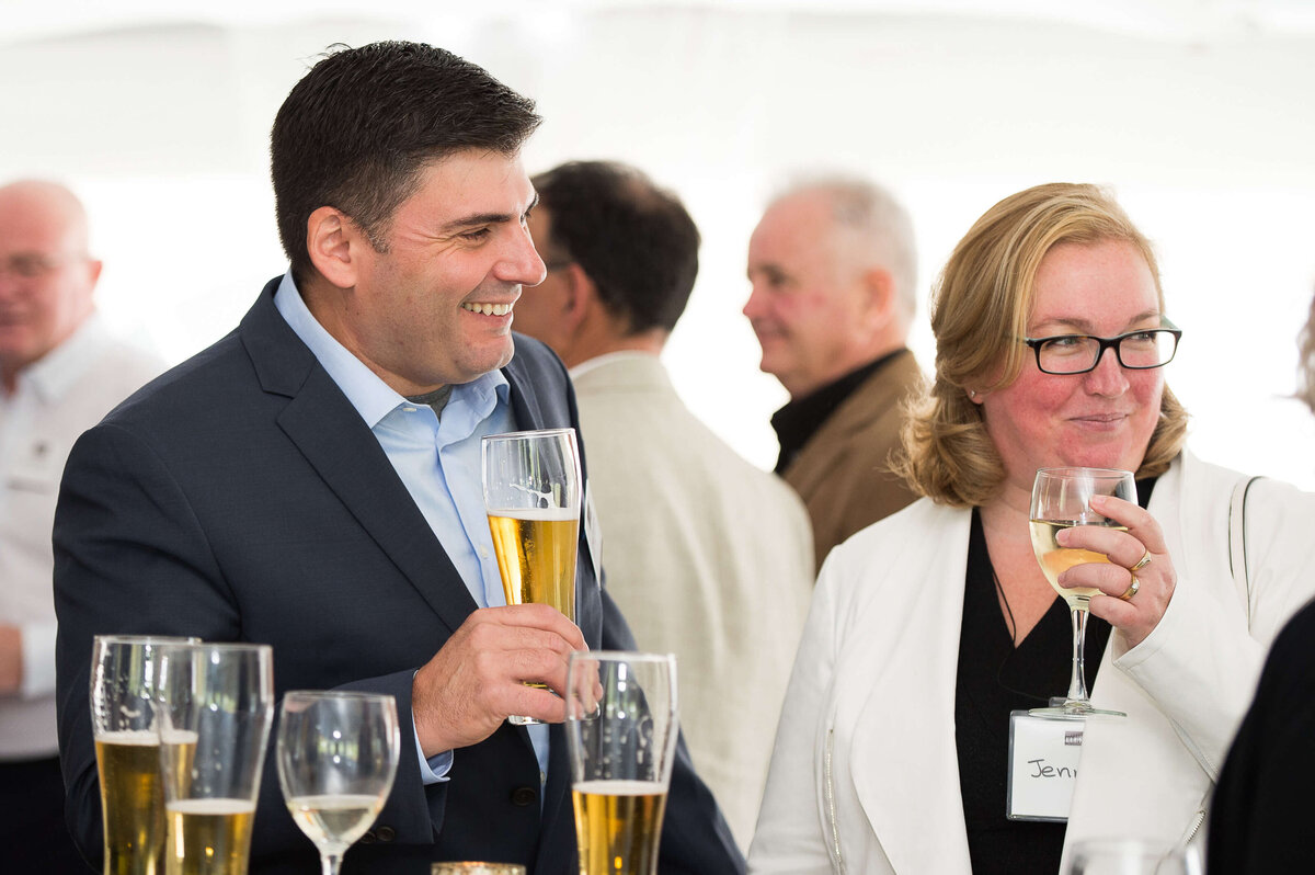 a candid photo of guests mingling at a corporate anniversary celebration.  Captured by Ottawa Event Photographer JEMMAN Photography COMMERCIAL