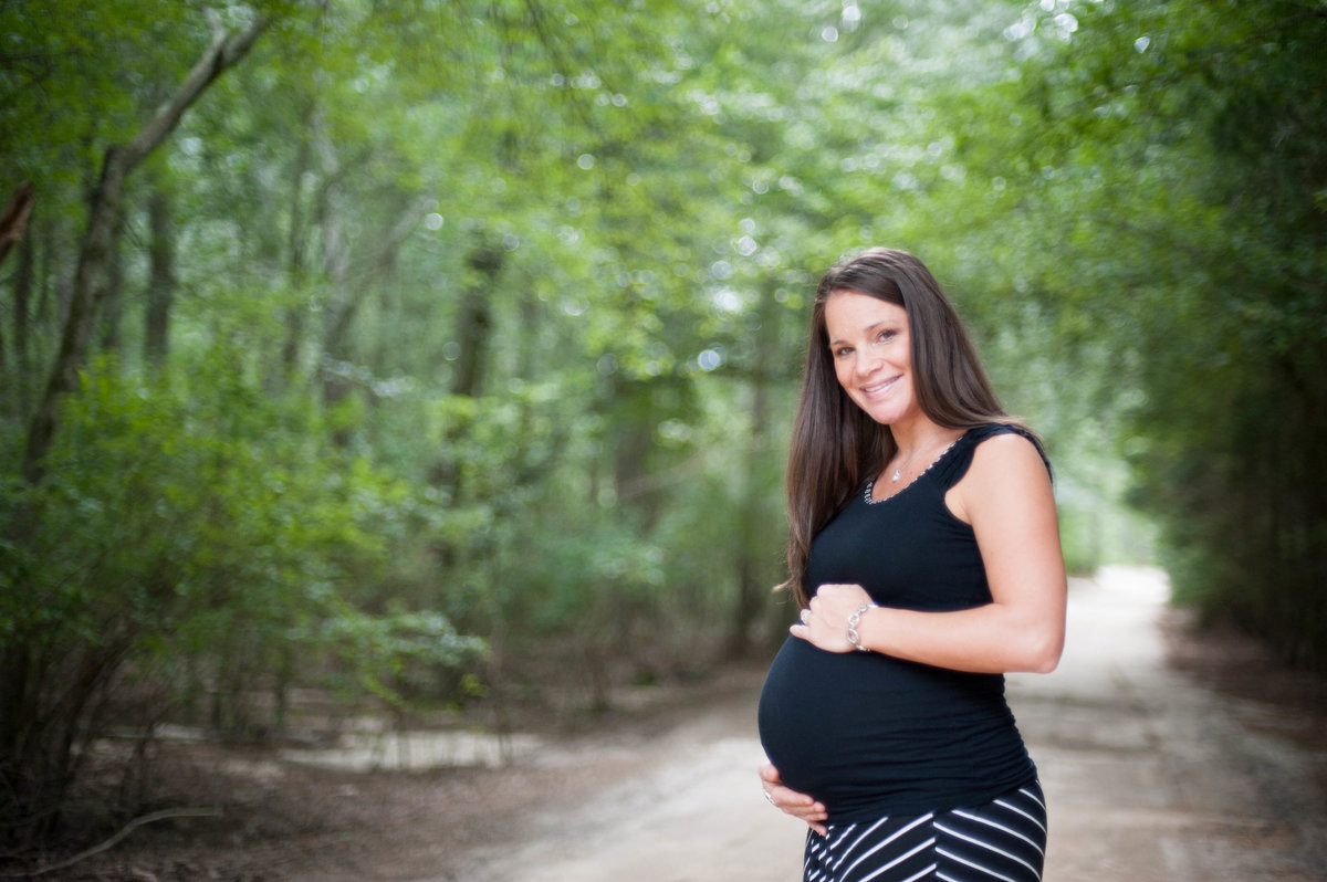 preganant woman on wooded patth