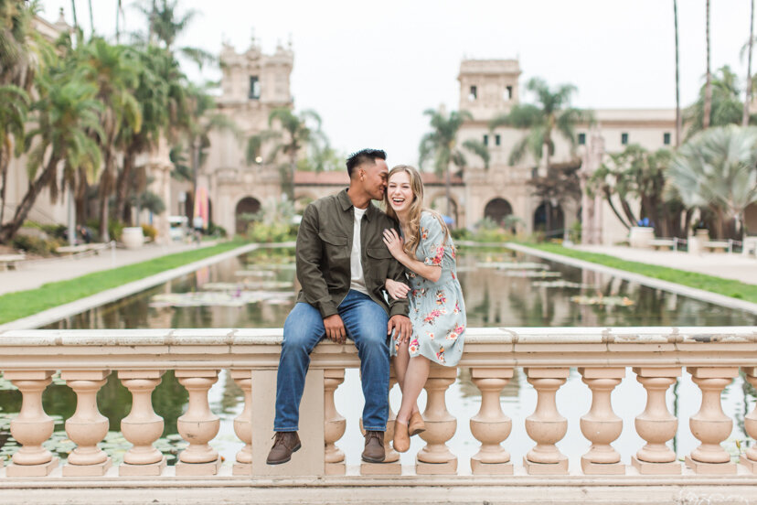 engaged couple by reflecting pond san diego