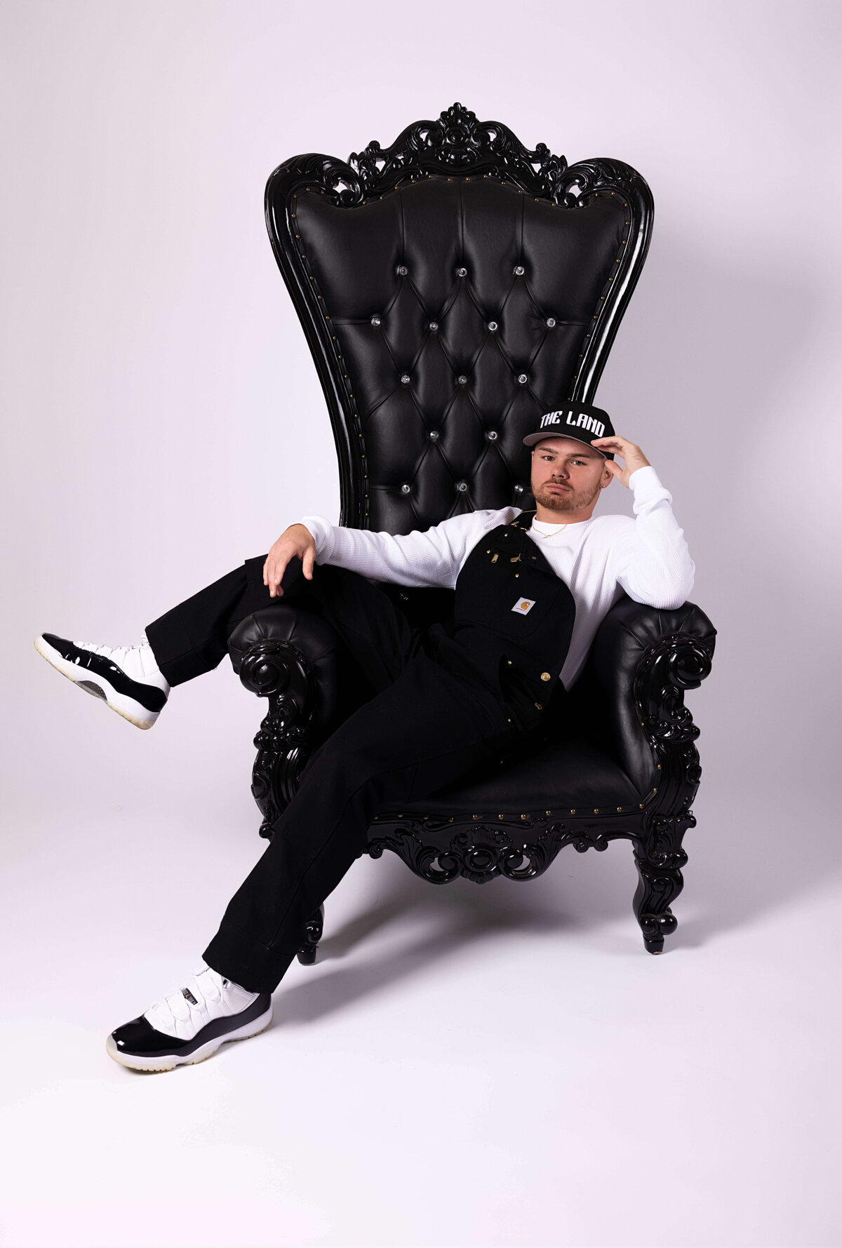 Professional boxer sitting in throne chair in birthday session with Reva Davis photography