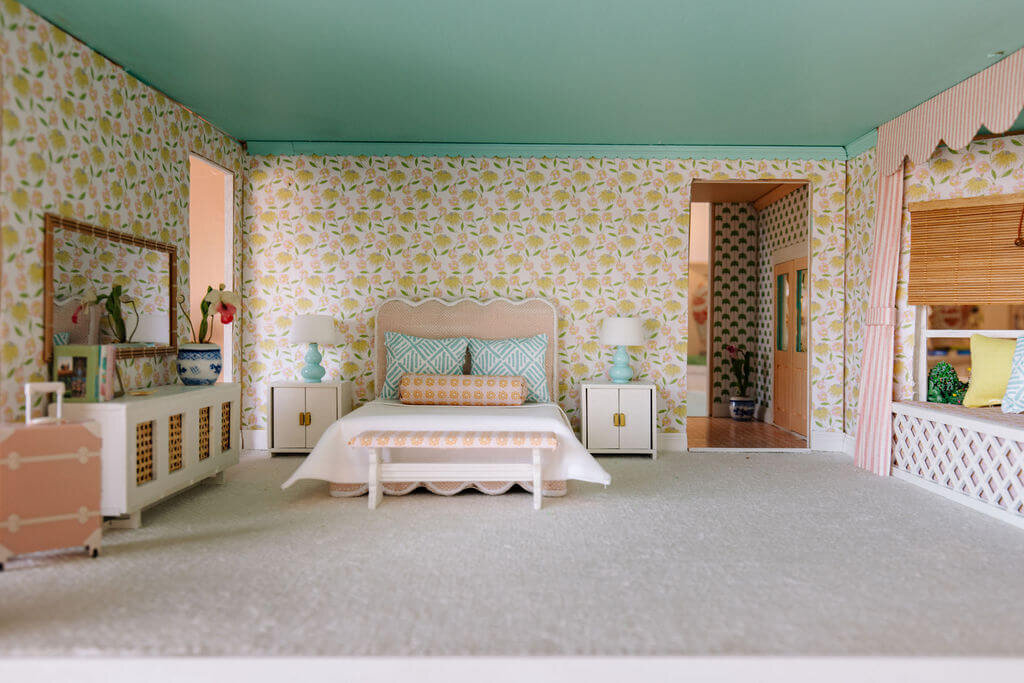 oyster creek studios petite palm beach dollhouse yellow and pink wallpaper with pink bed with light blue pillows in bedroom