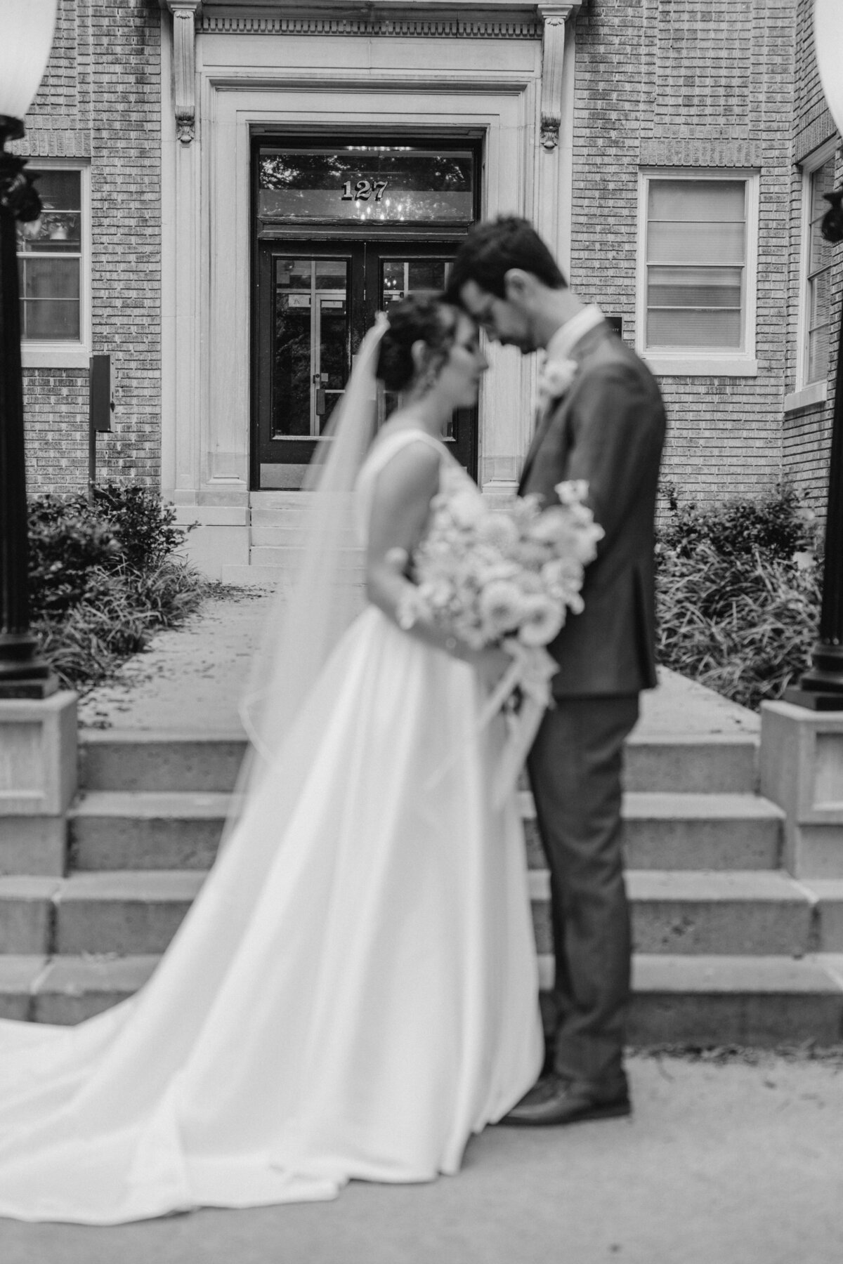 Bride and groom posing inside beautifully decorated Market Hall, Raleigh NC