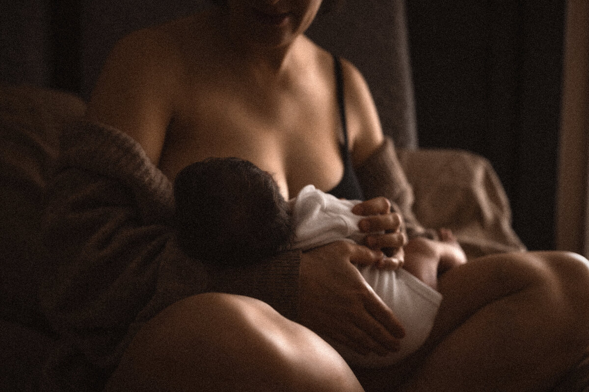 Mother nursing newborn baby