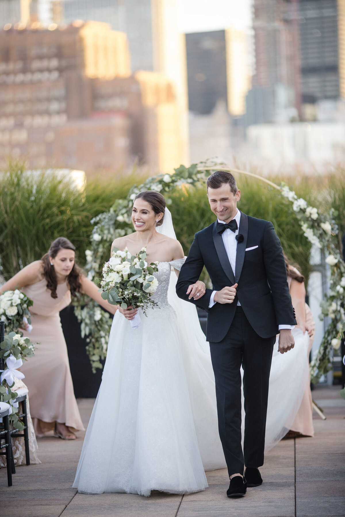 A couple walks down the aisle at a Tribeca Rooftop wedding in Manhattan