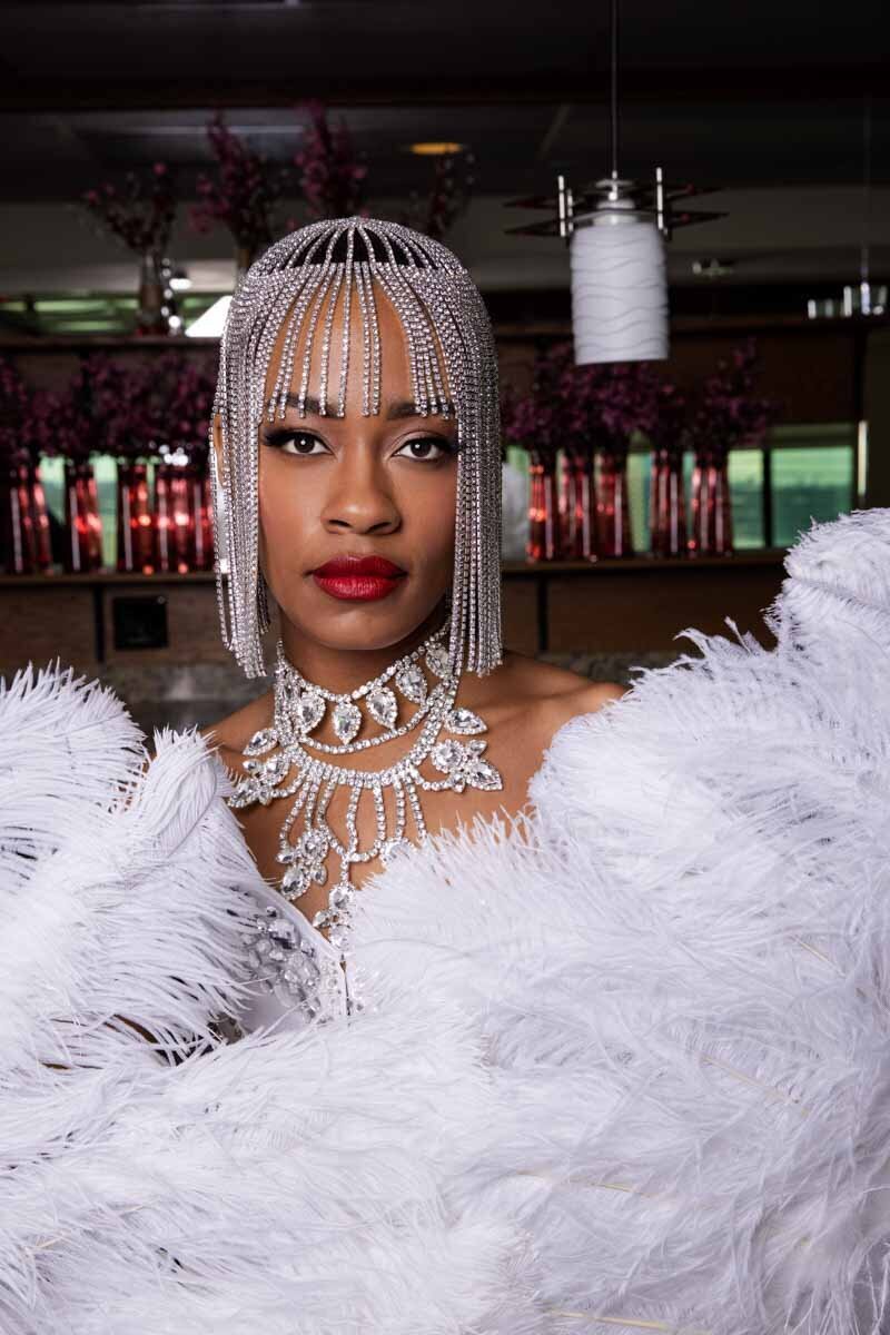Glamorous boudoir portrait of a black woman wearing silver headpiece