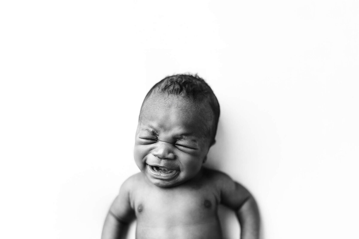 Black and white image of baby's crying face