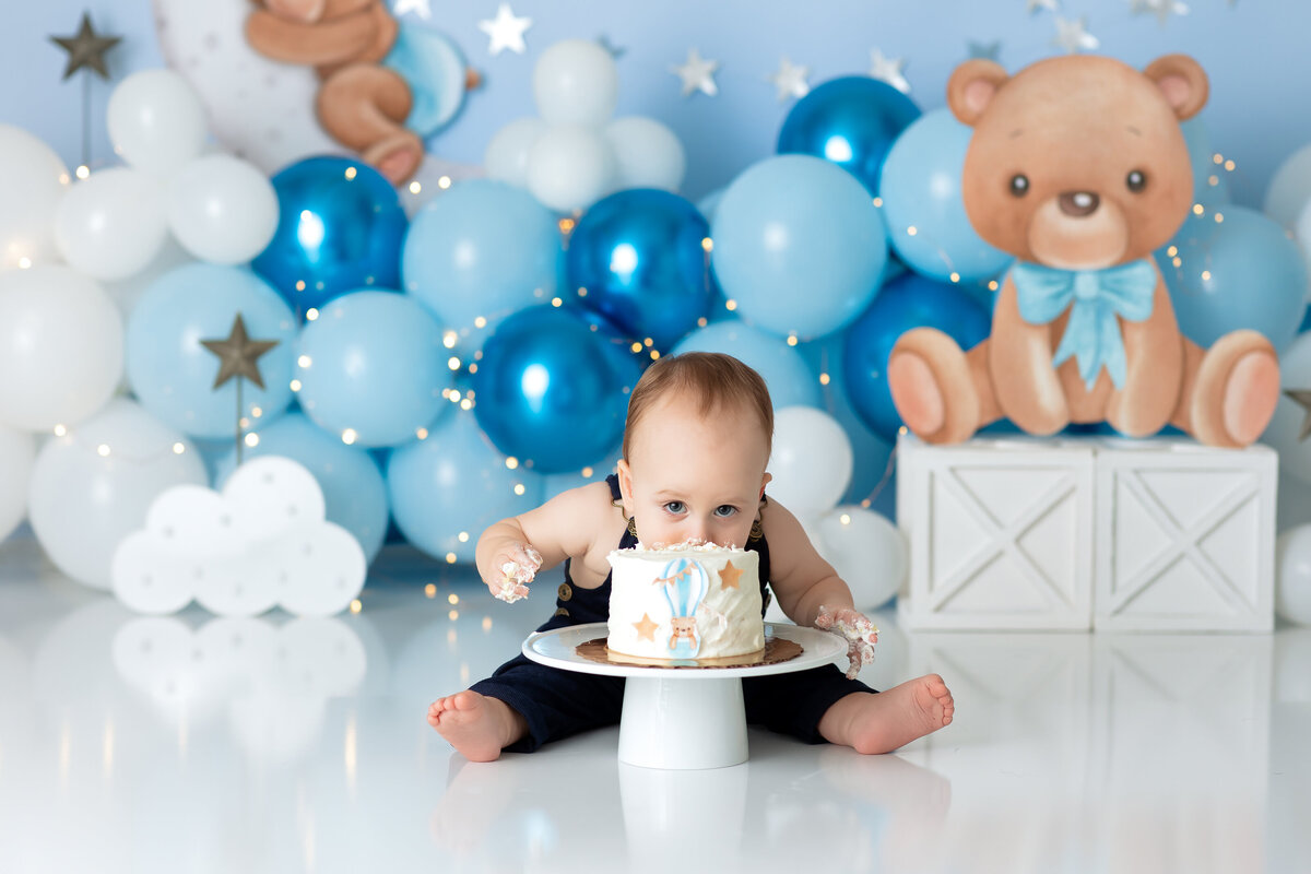 One year old Tampa baby enjoying a personalized luxury cake smash session with playful decorations
