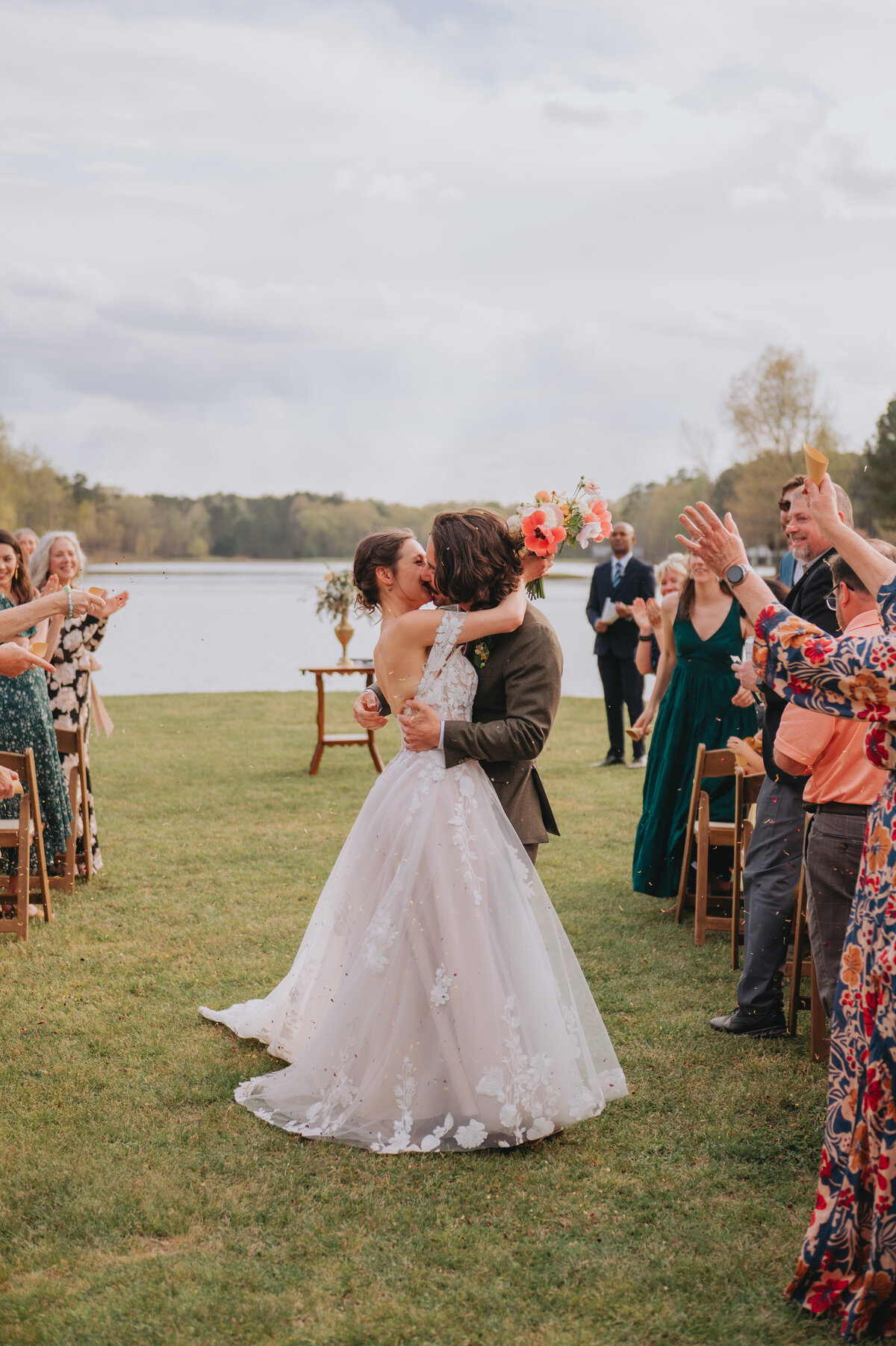 A couple who just got married kisses in the aisle