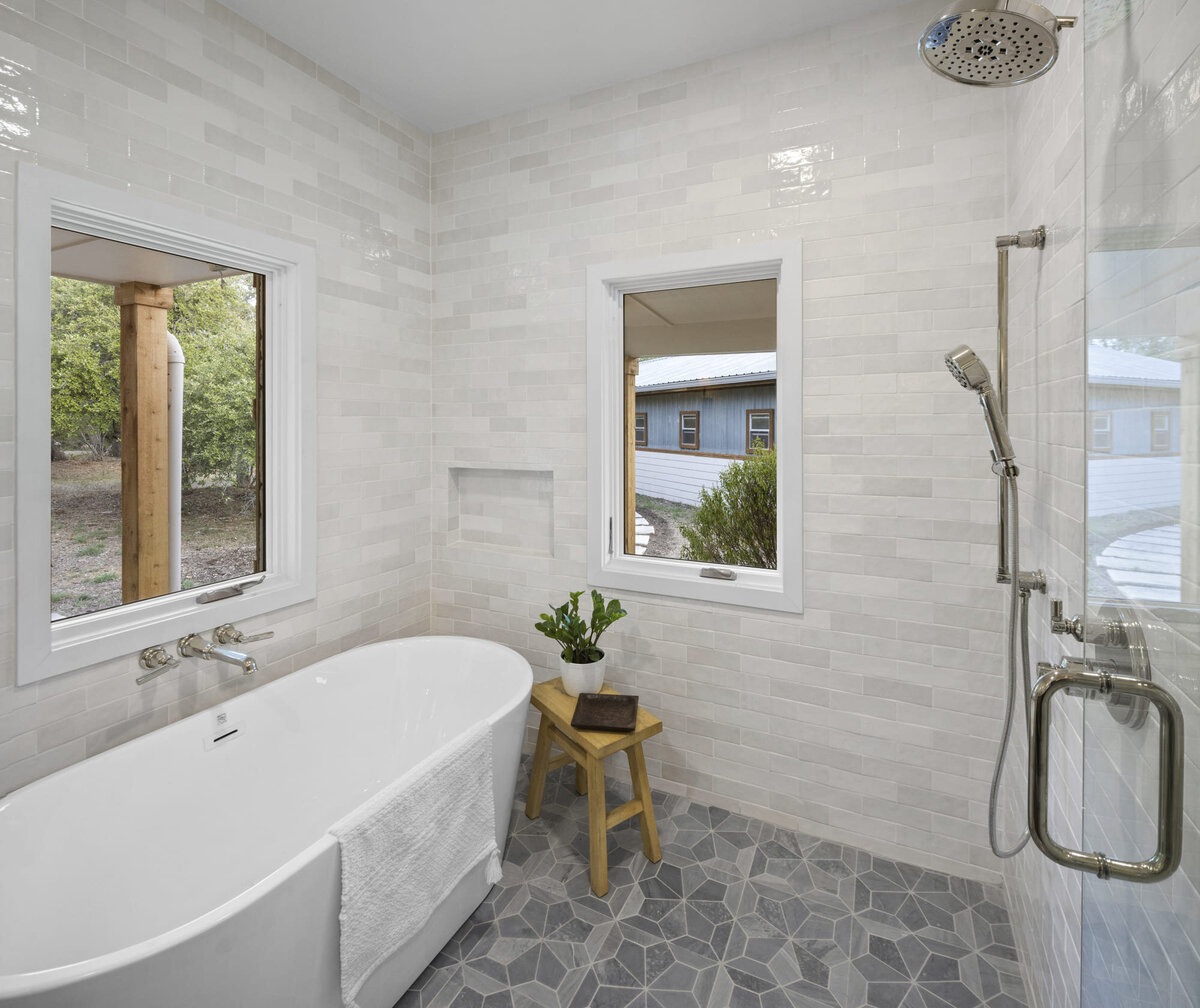 bathroom with large bathtub and shower