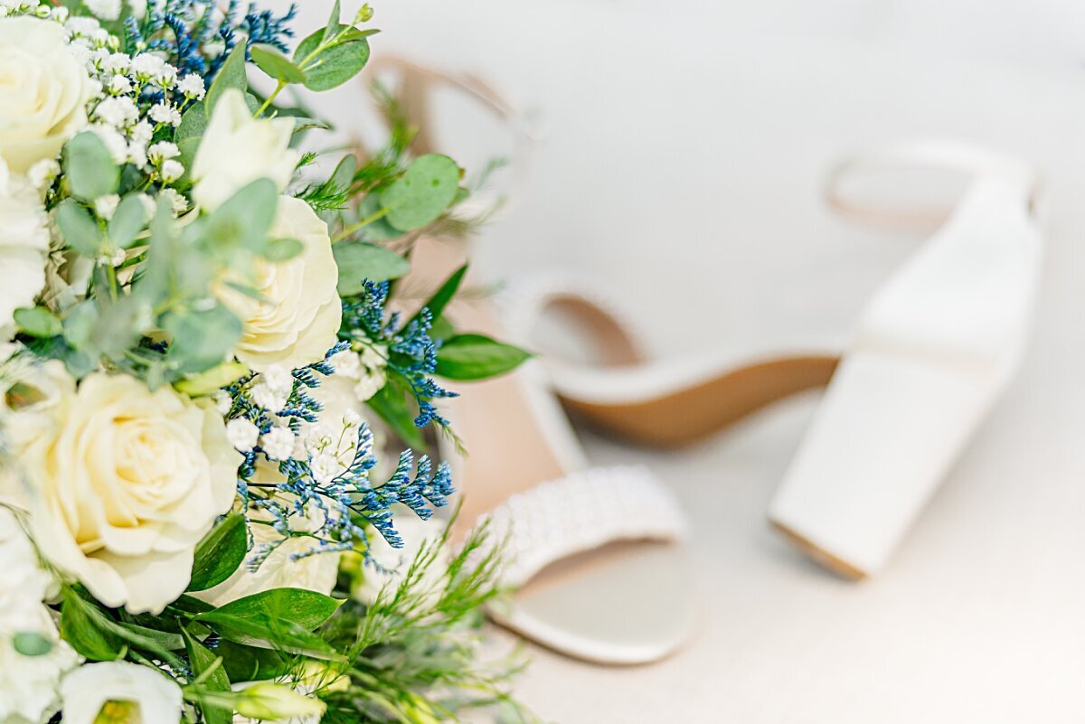 wedding-bouquet-beside-brides-shoes
