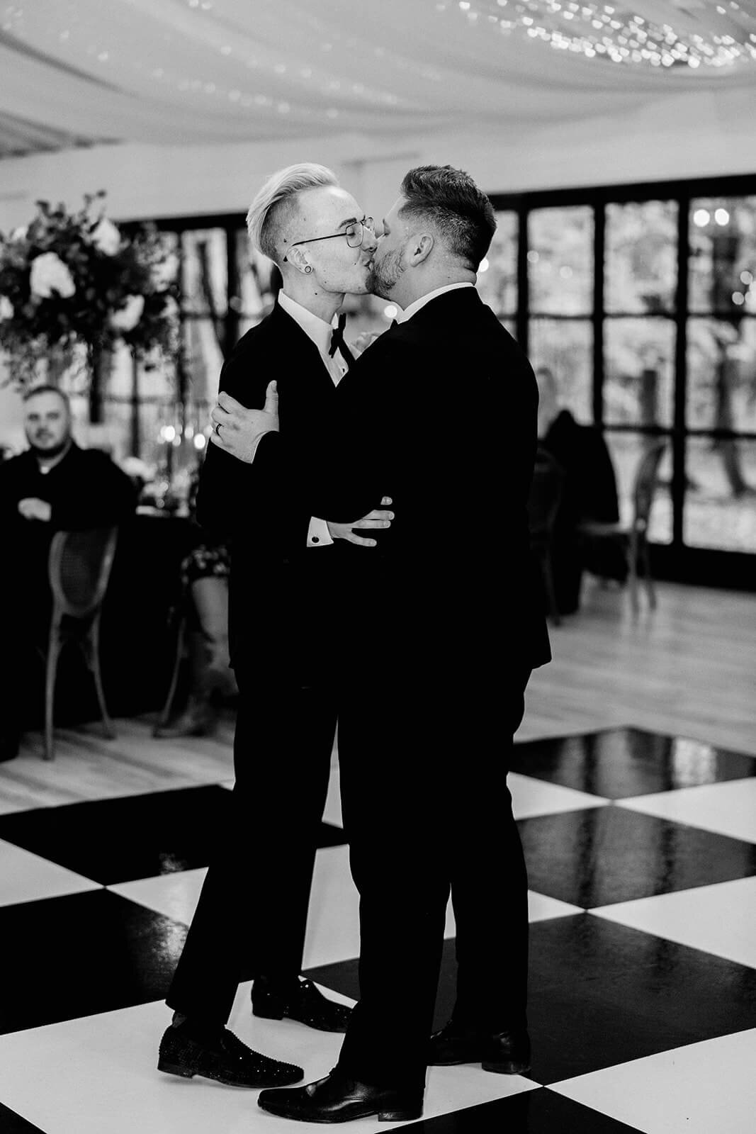 two grooms first dance kiss on Slate Black Dance Floor at Creencrest Manor Estate