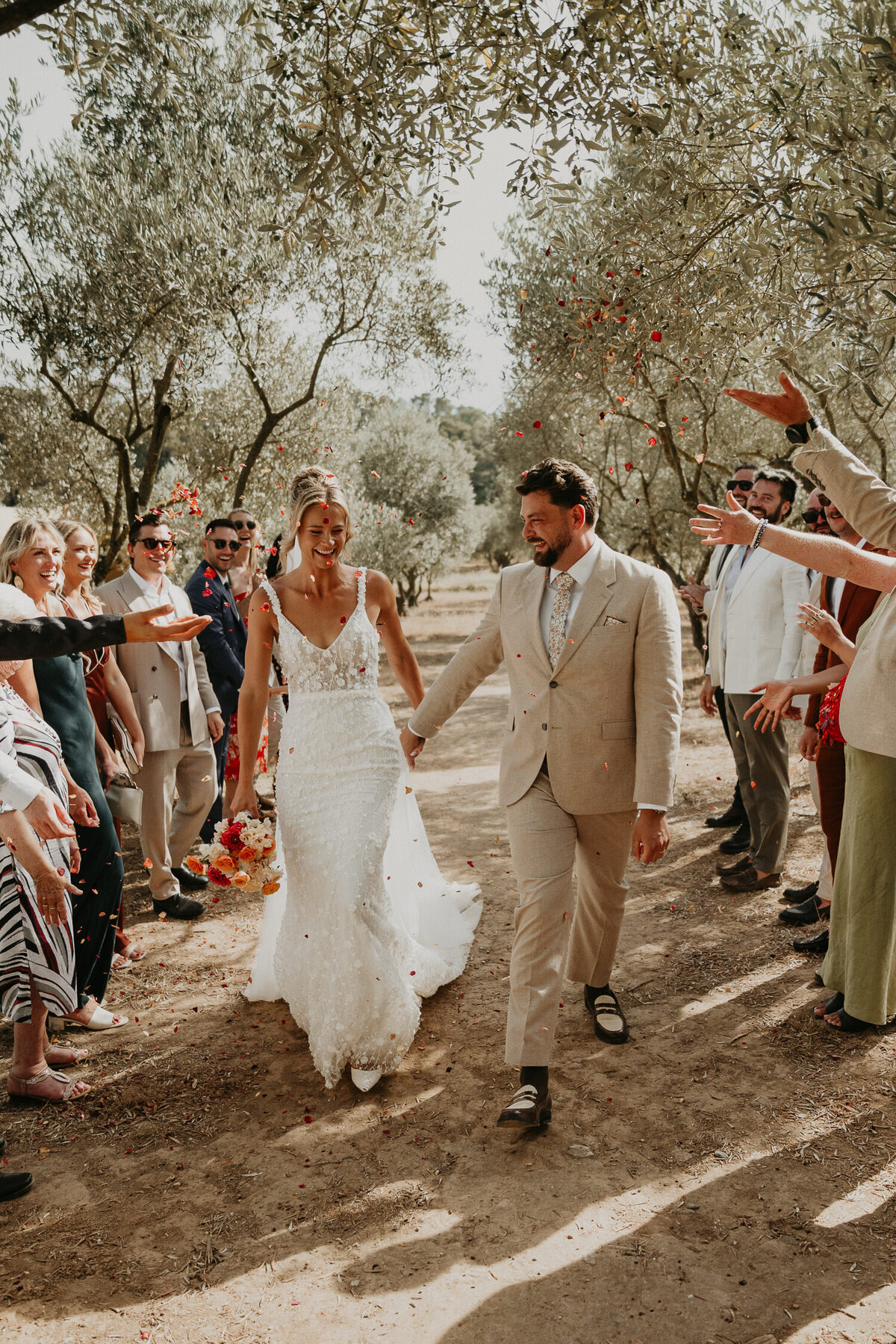 Bride and Groom walk through confetti at Chateau Canet in Carcassonne.