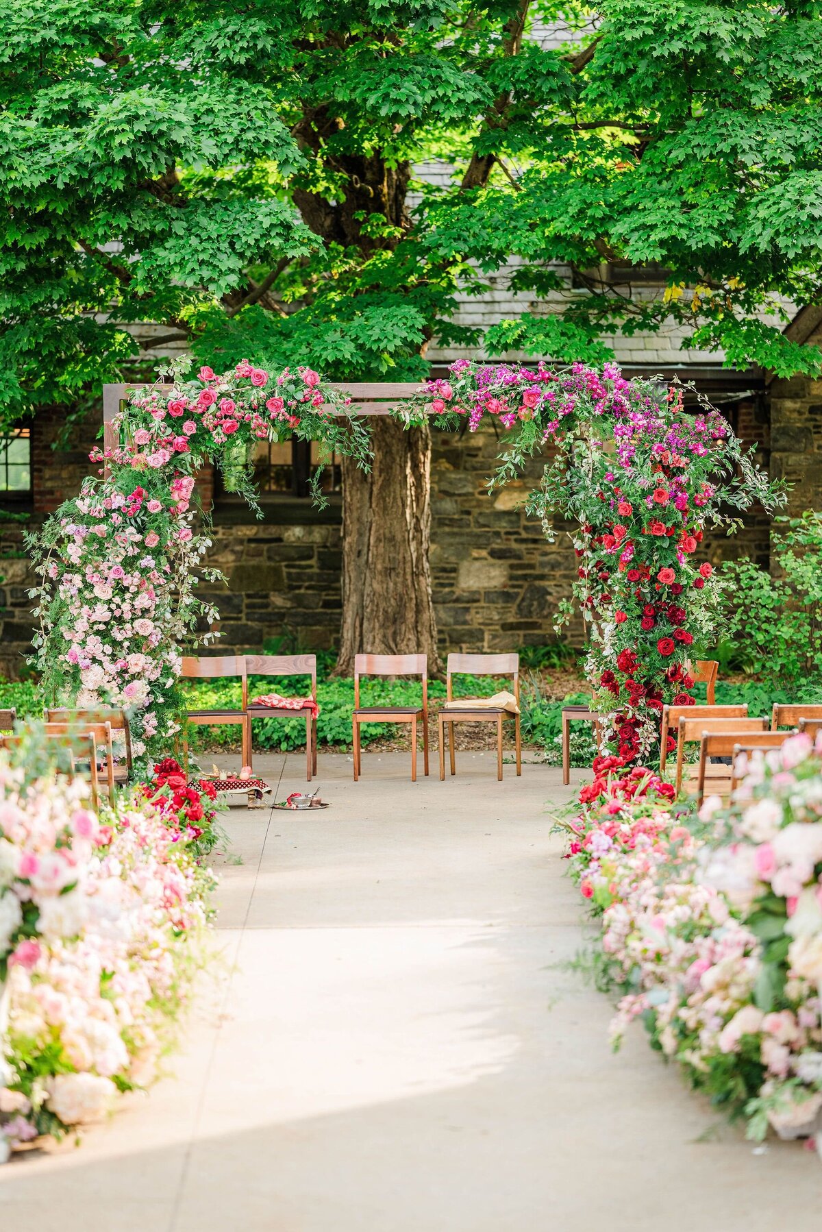 bright-pink-light-pink-red-floral-wedding-arch-wood-enza-events