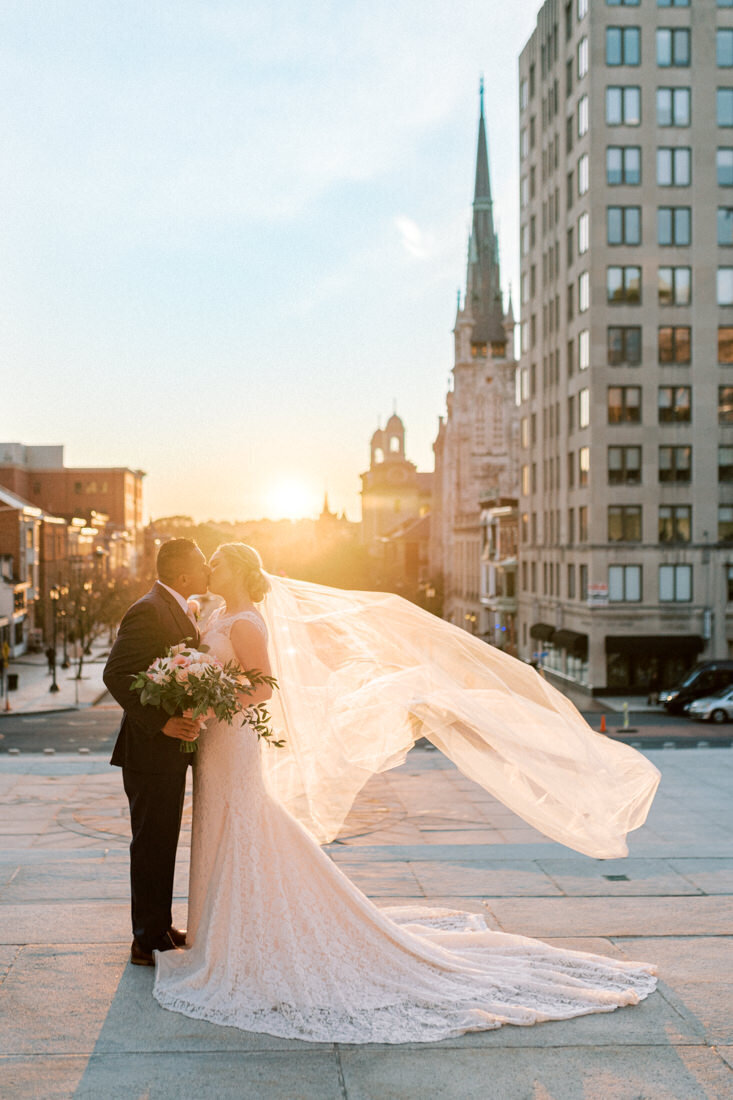 A bride and groom portrait at sunset downtown