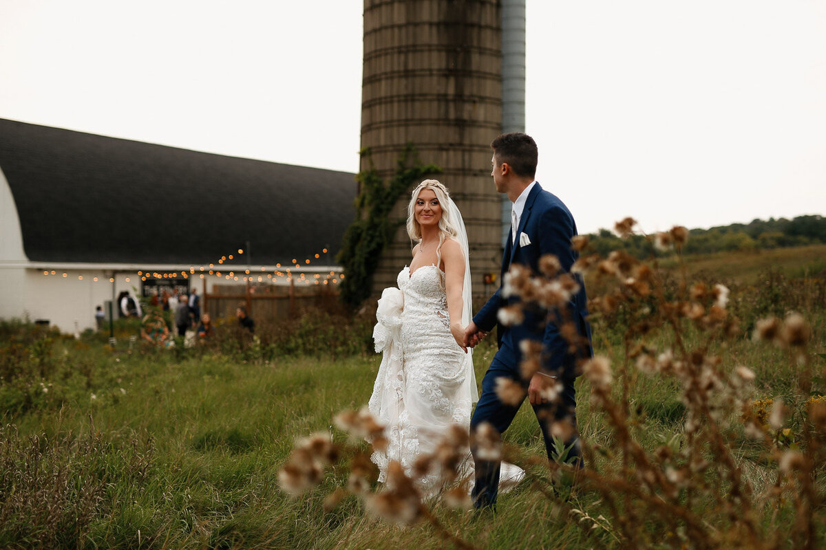 Bride and Groom in Montana walk on luxury Montana Ranch 