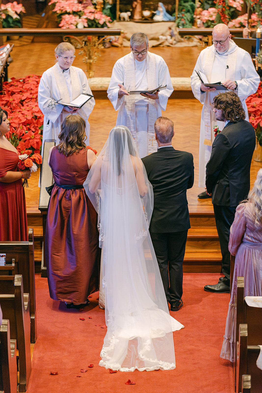 Elegant church ceremony moment as guests rise while bride enters aisle at San Antonio luxury wedding