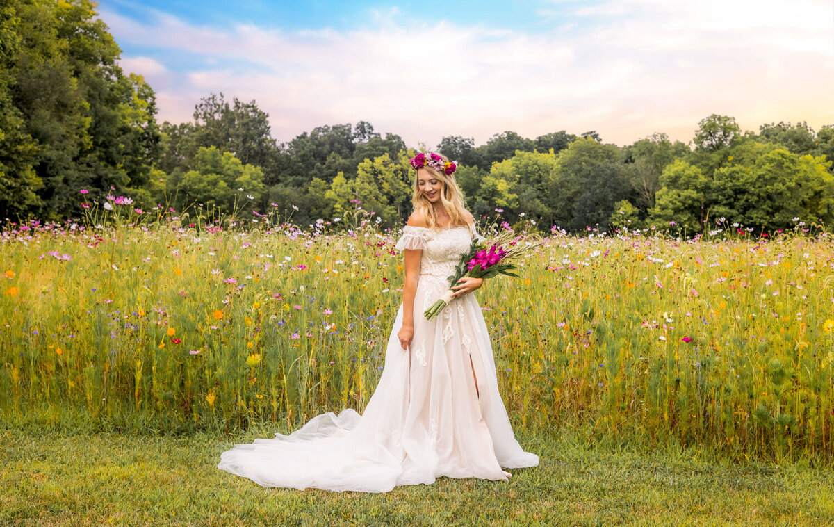 Bride with floral crown, standing gracefully in a meadow