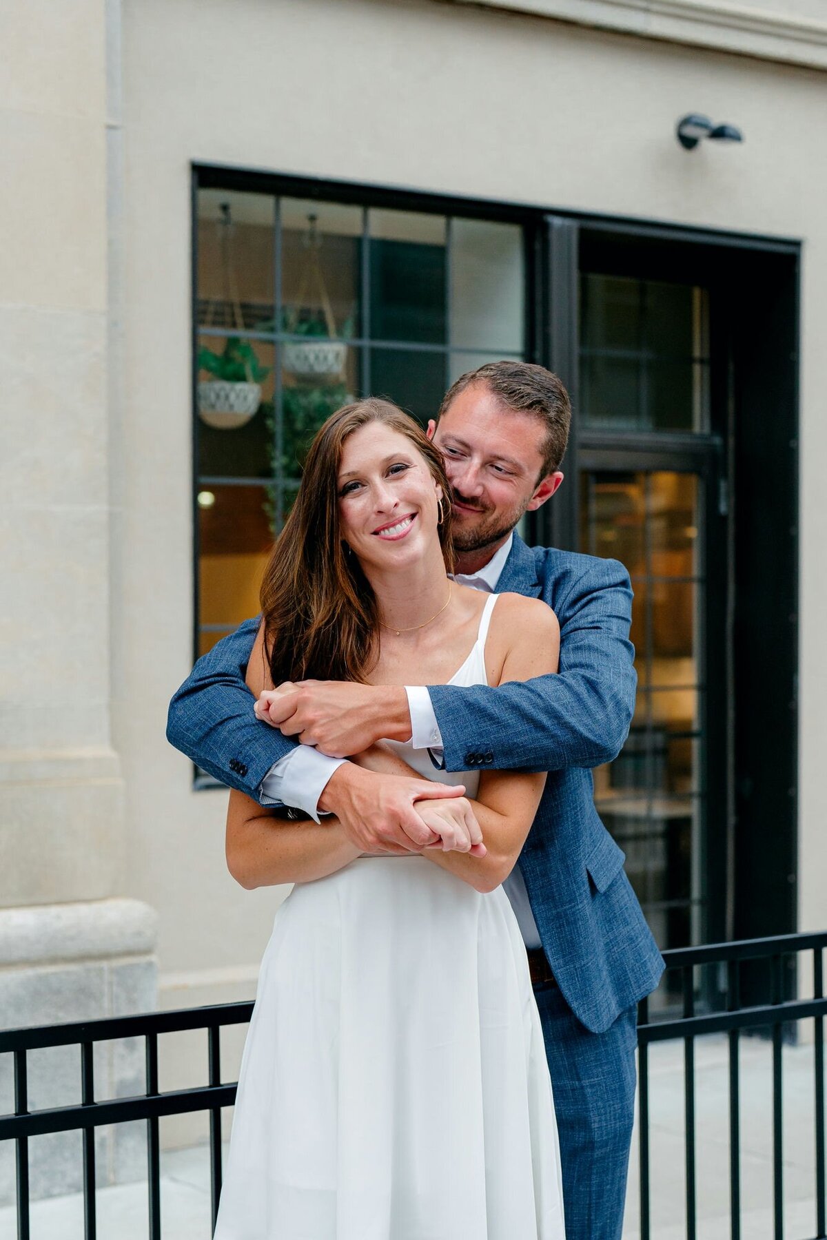 couple-laughing-hugging-outdoors-engagement