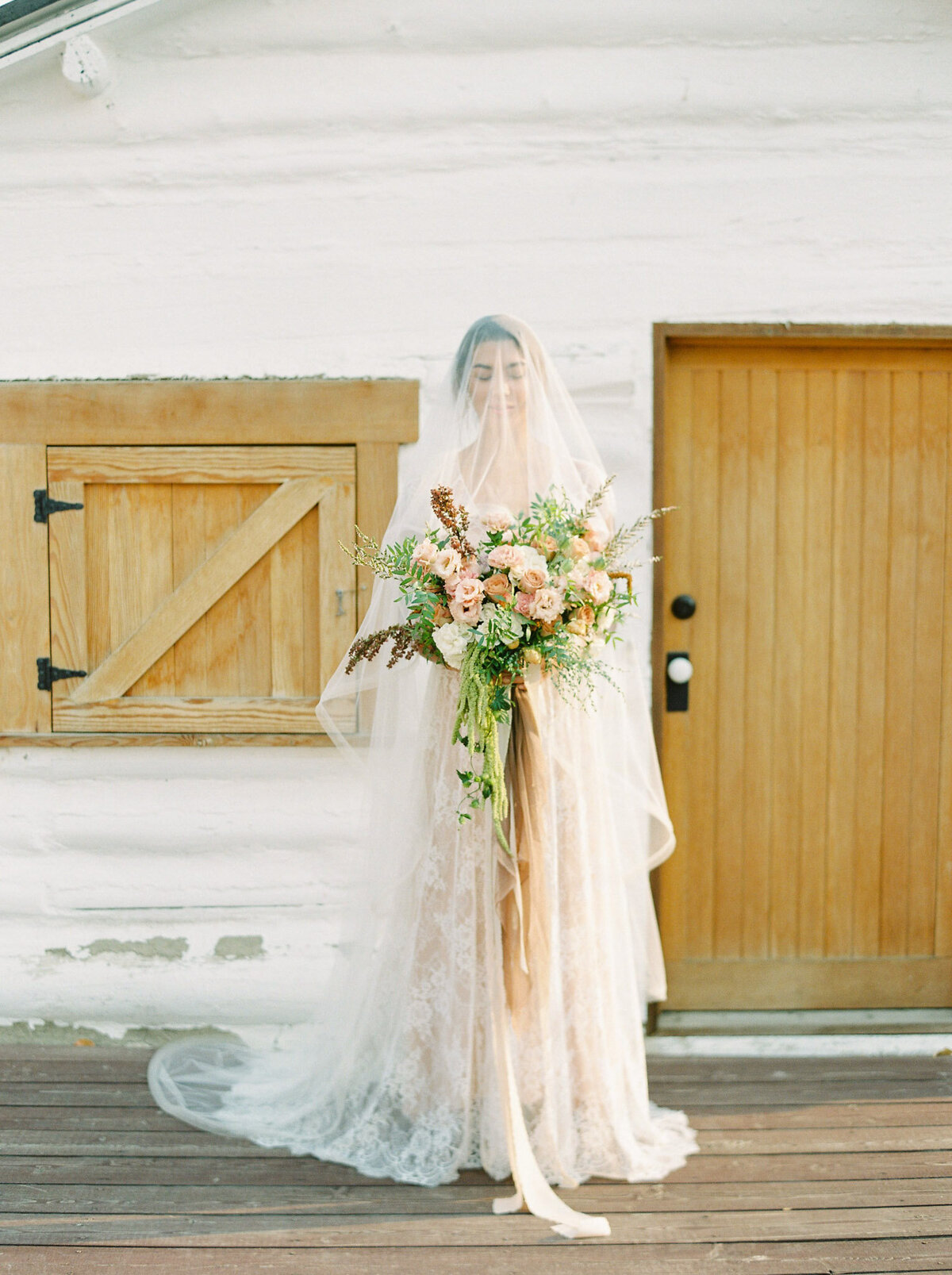 Whimsical and romantic bridal portrait outside of Deane House, historical and unique Calgary, Alberta wedding venue, featured on the Brontë Bride Vendor Guide.