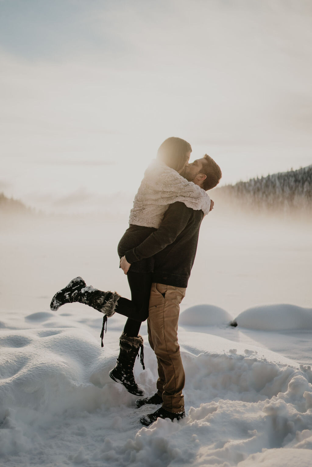 Couple kissing in the snow at Trillium Lake engagement session