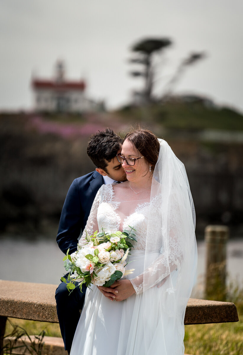 Stunning portraits of a bride and groom with the iconic Battery Point Lighthouse in Crescent City, California, providing a breathtaking coastal backdrop.